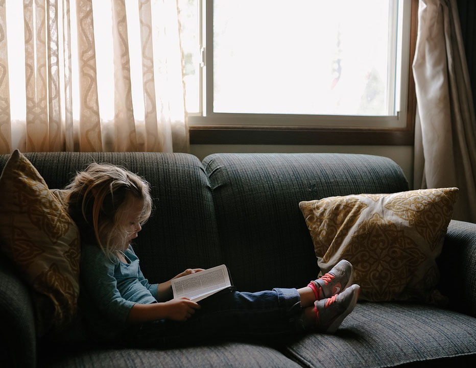 Child reading in front of secure window